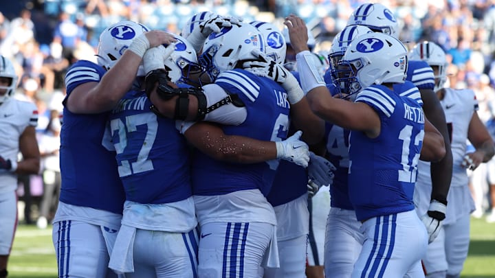 Oct 12, 2024; Provo, Utah, USA; The Brigham Young Cougars celebrate a touchdown by running back LJ Martin (27) against the Arizona Wildcats during the fourth quarter at LaVell Edwards Stadium. Mandatory Credit: Rob Gray-Imagn Images