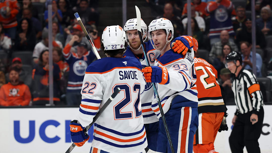 Feb 25, 2026; Anaheim, California, USA;  Edmonton Oilers center Ryan Nugent-Hopkins (93) celebrates with center Matt Savoie (22) and center Connor McDavid (middle) after scoring a goal during the first period against the Anaheim Ducks at Honda Center. Mandatory Credit: Kiyoshi Mio-Imagn Images