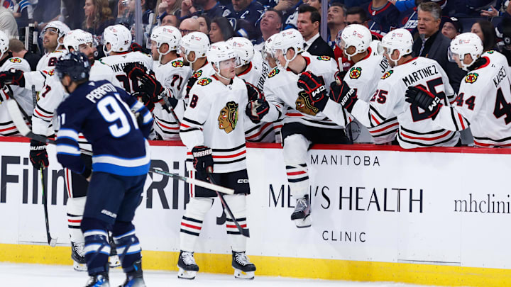 Oct 11, 2024; Winnipeg, Manitoba, CAN;  Chicago Blackhawks forward Ryan Donato (8) is congratulated by his team mates on his goal against the Winnipeg Jets during the second period at Canada Life Centre. Mandatory Credit: Terrence Lee-Imagn Images