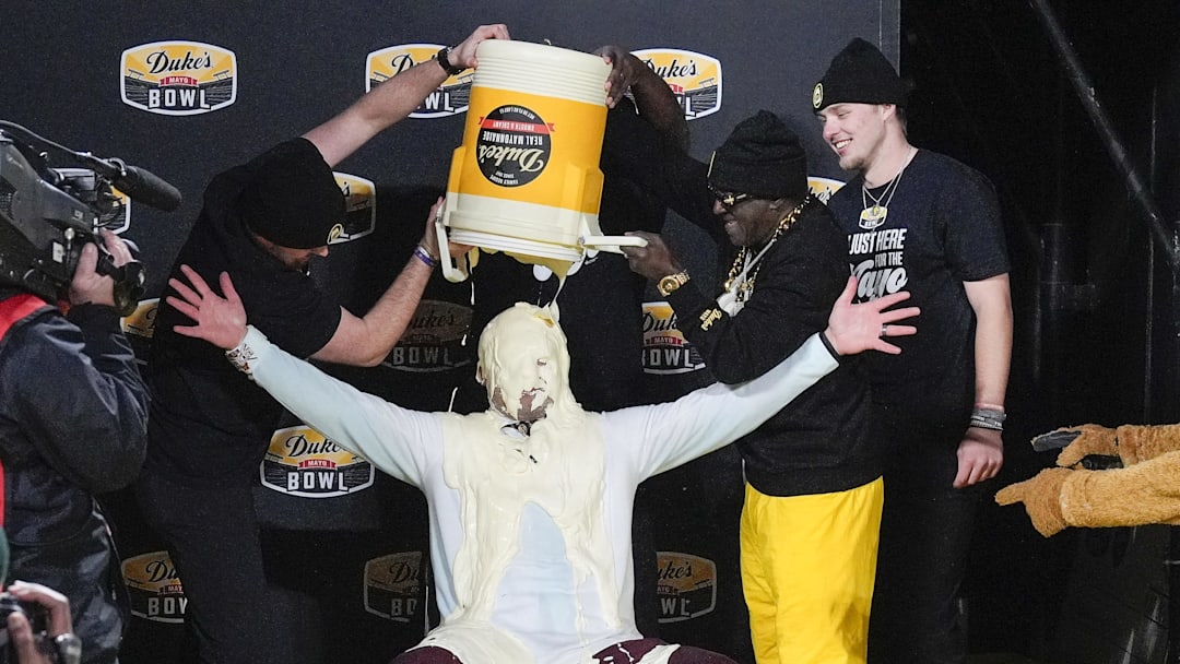 Jan 3, 2025; Charlotte, NC, USA;  Minnesota Golden Gophers head coach P.J. Fleck receives the ceremonial mayo dump after his teams’ win over Virginia Tech Hokies at the Duke’s Mayo Bowl at Bank of America Stadium. Mandatory Credit: Jim Dedmon-Imagn Images