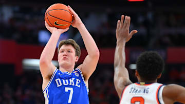 Feb 5, 2025; Syracuse, New York, USA; Duke basketball guard Kon Knueppel (7) shoots against Syracuse Orange guard J.J. Starling (2) during the first half at the JMA Wireless Dome. 