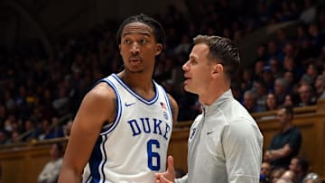 Nov 21, 2025; Durham, North Carolina, USA; Duke Blue Devils head coach Jon Scheyer (right) talks to forward Maliq Brown (6) during the second half against the Niagara Purple Eagles at Cameron Indoor Stadium. Mandatory Credit: Rob Kinnan-Imagn Images
