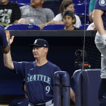 Seattle Mariners shortstop J.P. Crawford (3) is congratulated by manager Scott Servais (9) after scoring against the Miami Marlins during the first inning of a game at loanDepot Park.