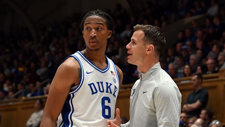Nov 21, 2025; Durham, North Carolina, USA; Duke Blue Devils head coach Jon Scheyer (right) talks to forward Maliq Brown (6) during the second half against the Niagara Purple Eagles at Cameron Indoor Stadium. Mandatory Credit: Rob Kinnan-Imagn Images