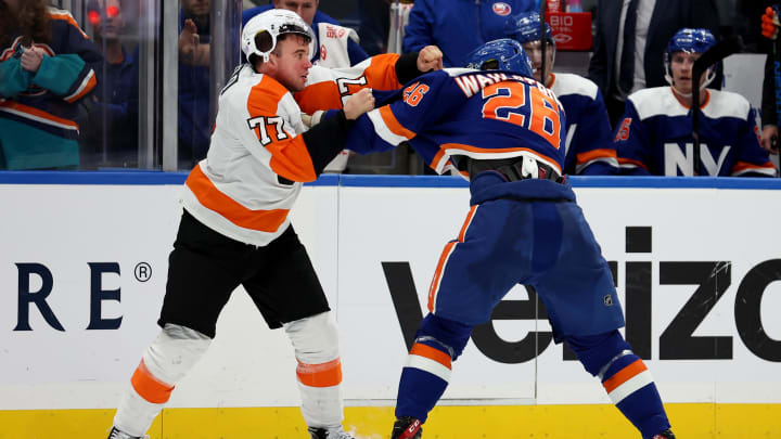 Nov 26, 2022; Elmont, New York, USA; Philadelphia Flyers defenseman Tony DeAngelo (77) fights New York Islanders right wing Oliver Wahlstrom (26) during the third period at UBS Arena. Mandatory Credit: Brad Penner-USA TODAY Sports