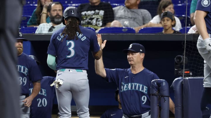 Seattle Mariners shortstop J.P. Crawford (3) is congratulated by manager Scott Servais (9) after scoring against the Miami Marlins during the first inning of a game at loanDepot Park.