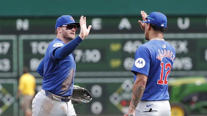 Aug 28, 2024; Pittsburgh, Pennsylvania, USA;  Chicago Cubs left fielder Ian Happ (8) and second baseman  Luis Vazquez (12) celebrate after defeating the Pittsburgh Pirates at PNC Park. Chicago won 14-10.Mandatory Credit: Charles LeClaire-Imagn Images