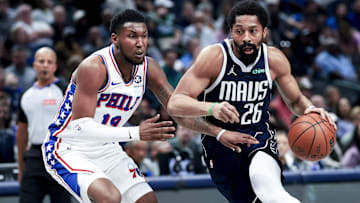 Mar 16, 2025; Dallas, Texas, USA;  Dallas Mavericks guard Spencer Dinwiddie (26) drives to the basket as Philadelphia 76ers forward Justin Edwards (19) defends during the first half at American Airlines Center. Mandatory Credit: Kevin Jairaj-Imagn Images