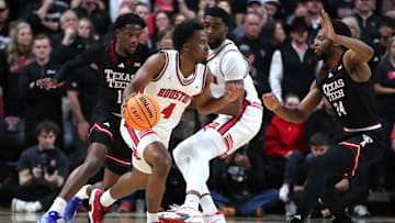 Feb 24, 2025; Lubbock, Texas, USA;  Houston Cougars guard LJ Cryer (4) dribbles the ball against Texas Tech Red Raiders guard Kerwin Walton (24) in the first half at United Supermarkets Arena. Mandatory Credit: Michael C. Johnson-Imagn Images