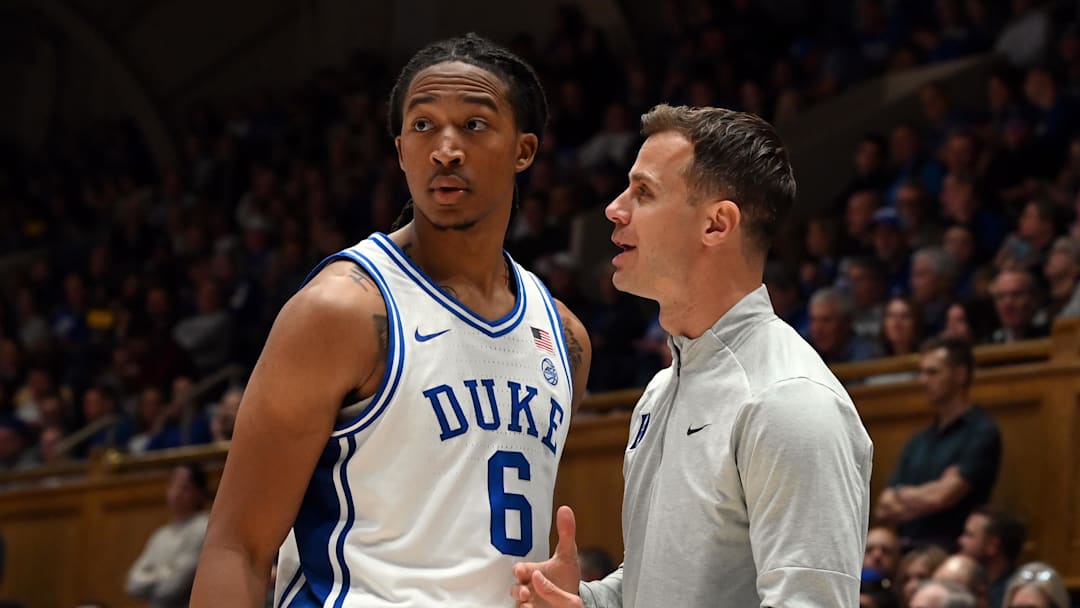 Nov 21, 2025; Durham, North Carolina, USA; Duke Blue Devils head coach Jon Scheyer (right) talks to forward Maliq Brown (6) during the second half against the Niagara Purple Eagles at Cameron Indoor Stadium. Mandatory Credit: Rob Kinnan-Imagn Images