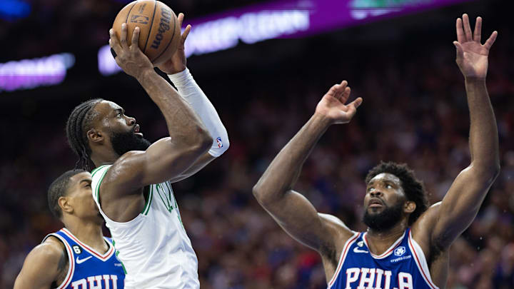 May 11, 2023; Philadelphia, Pennsylvania, USA; Boston Celtics guard Jaylen Brown (7) shoots the ball in front of Philadelphia 76ers center Joel Embiid (21) during the third quarter in game six of the 2023 NBA playoffs at Wells Fargo Center. Mandatory Credit: Bill Streicher-Imagn Images