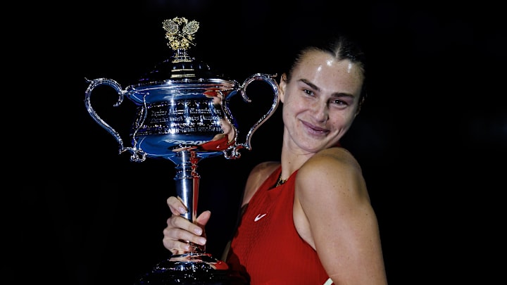 Aryna Sabalenka holds the 2024 Australian Open trophy after winning the tournament.
