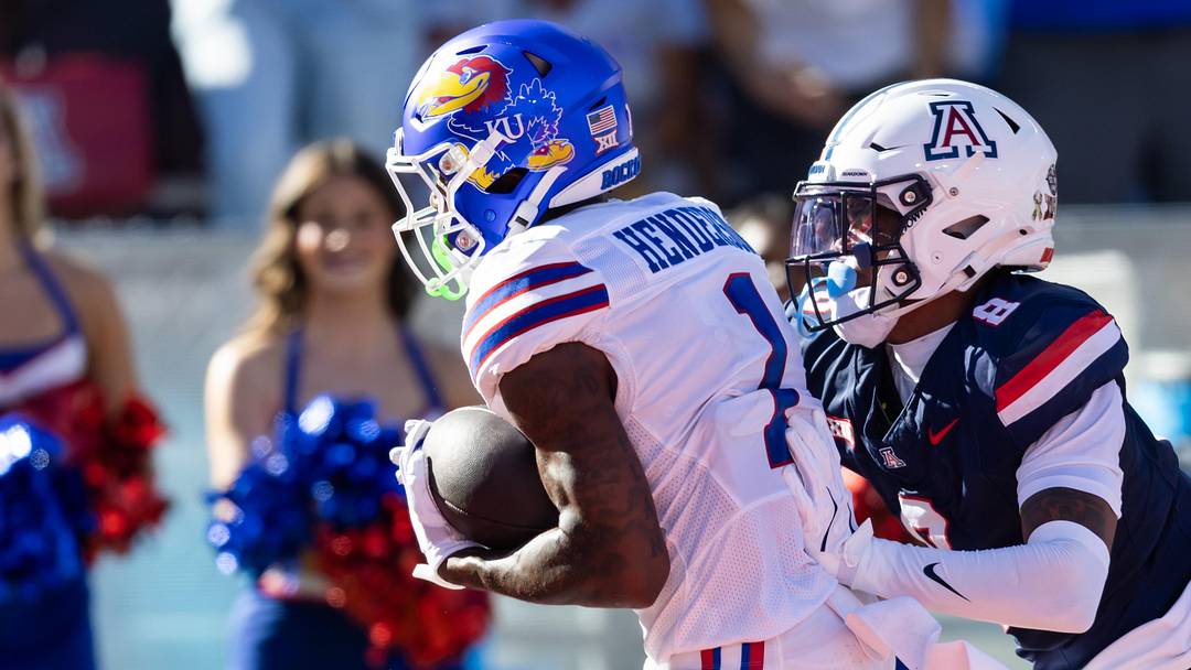 Nov 8, 2025; Tucson, Arizona, USA; Kansas Jayhawks wide receiver Emmanuel Henderson Jr. (1) runs for a touchdown against Arizona Wildcats defensive back Jay'Vion Cole (8) at Arizona Stadium. Mandatory Credit: Mark J. Rebilas-Imagn Images