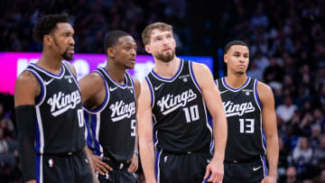 Jan 5, 2024; Sacramento, California, USA; Sacramento Kings guard Malik Monk (0) and guard De'Aaron Fox (5) and forward Domantas Sabonis (10) and forward Keegan Murray (13) look on during a free throw during the fourth quarter against the Toronto Raptors at Golden 1 Center. Mandatory Credit: Ed Szczepanski-USA TODAY Sports