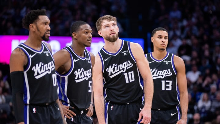 Jan 5, 2024; Sacramento, California, USA; Sacramento Kings guard Malik Monk (0) and guard De'Aaron Fox (5) and forward Domantas Sabonis (10) and forward Keegan Murray (13) look on during a free throw during the fourth quarter against the Toronto Raptors at Golden 1 Center. Mandatory Credit: Ed Szczepanski-USA TODAY Sports