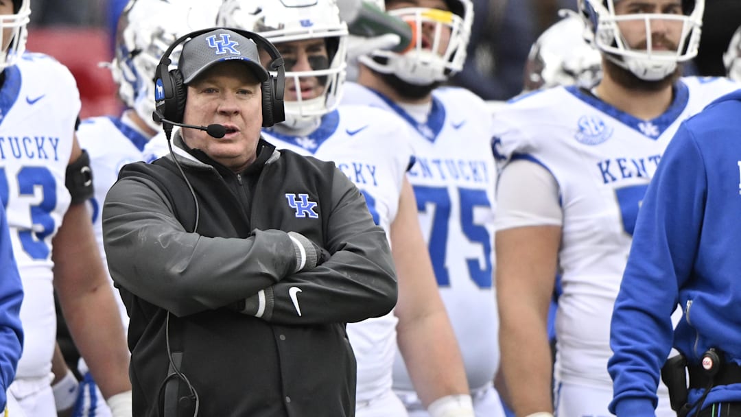 Nov 29, 2025; Louisville, Kentucky, USA;  Kentucky Wildcats head coach Mark Stoops watches from the sideline during the second half against the Louisville Cardinals at L&N Federal Credit Union Stadium. Louisville defeated Kentucky 41-0. Mandatory Credit: Jamie Rhodes-Imagn Images