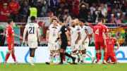 USA players react to the 1-1 draw vs. Wales. 