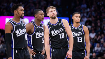 Jan 5, 2024; Sacramento, California, USA; Sacramento Kings guard Malik Monk (0) and guard De'Aaron Fox (5) and forward Domantas Sabonis (10) and forward Keegan Murray (13) look on during a free throw during the fourth quarter against the Toronto Raptors at Golden 1 Center. Mandatory Credit: Ed Szczepanski-USA TODAY Sports