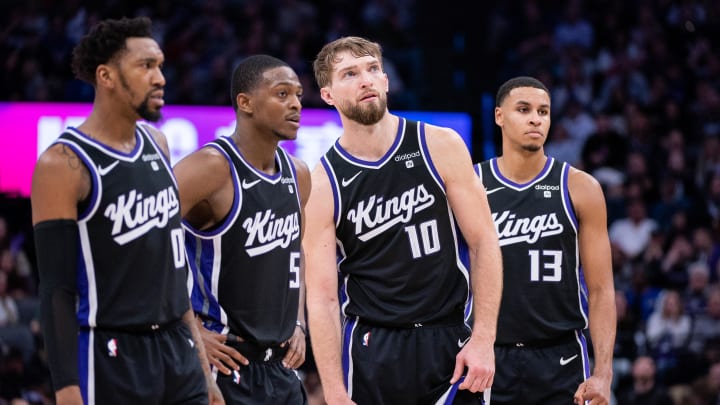 Jan 5, 2024; Sacramento, California, USA; Sacramento Kings guard Malik Monk (0) and guard De'Aaron Fox (5) and forward Domantas Sabonis (10) and forward Keegan Murray (13) look on during a free throw during the fourth quarter against the Toronto Raptors at Golden 1 Center. Mandatory Credit: Ed Szczepanski-USA TODAY Sports