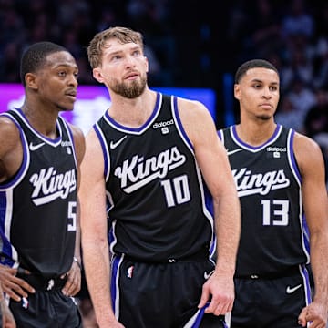 Jan 5, 2024; Sacramento, California, USA; Sacramento Kings guard Malik Monk (0) and guard De'Aaron Fox (5) and forward Domantas Sabonis (10) and forward Keegan Murray (13) look on during a free throw during the fourth quarter against the Toronto Raptors at Golden 1 Center. Mandatory Credit: Ed Szczepanski-Imagn Images