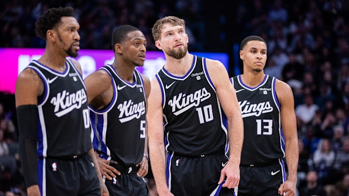 Jan 5, 2024; Sacramento, California, USA; Sacramento Kings guard Malik Monk (0) and guard De'Aaron Fox (5) and forward Domantas Sabonis (10) and forward Keegan Murray (13) look on during a free throw during the fourth quarter against the Toronto Raptors at Golden 1 Center. Mandatory Credit: Ed Szczepanski-Imagn Images