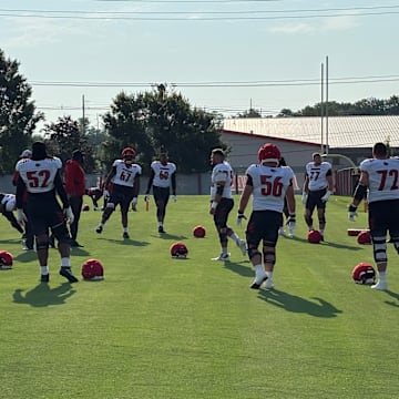Louisville offensive linemen warmup prior to a fall camp practice