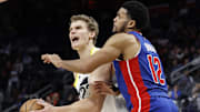 Dec 19, 2024; Detroit, Michigan, USA;  Utah Jazz forward Lauri Markkanen (23) is fouled by Detroit Pistons forward Tobias Harris (12) in the fourth quarter at Little Caesars Arena. Mandatory Credit: Rick Osentoski-Imagn Images