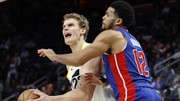 Dec 19, 2024; Detroit, Michigan, USA;  Utah Jazz forward Lauri Markkanen (23) is fouled by Detroit Pistons forward Tobias Harris (12) in the fourth quarter at Little Caesars Arena. Mandatory Credit: Rick Osentoski-Imagn Images