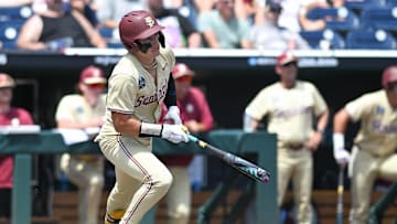 Jun 16, 2024; Omaha, NE, USA;  Florida State Seminoles designated hitter Marco Dinges (43) singles in a run against the Virginia Cavaliers during the fifth inning at Charles Schwab Field Omaha. Mandatory Credit: Steven Branscombe-Imagn Images