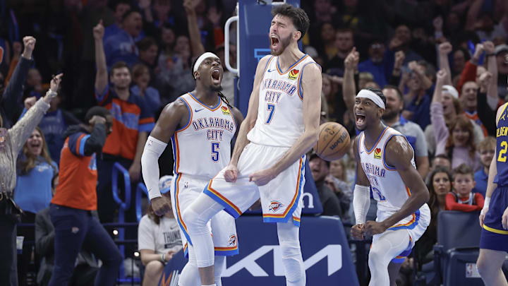 Dec 8, 2023; Oklahoma City, Oklahoma, USA; Oklahoma City Thunder forward Chet Holmgren (7), guard Luguentz Dort (5) and guard Shai Gilgeous-Alexander (2) celebrate after Chet Holmgren scores a basket against the Golden State Warriors during the second half at Paycom Center. Mandatory Credit: Alonzo Adams-Imagn Images