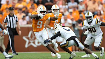 Sep 6, 2025; Knoxville, Tennessee, USA; Tennessee Volunteers running back Star Thomas (9) runs with the ball against East Tennessee State Buccaneers defensive back Jivon Oggs (6) during the second quarter at Neyland Stadium. Mandatory Credit: Randy Sartin-Imagn Images