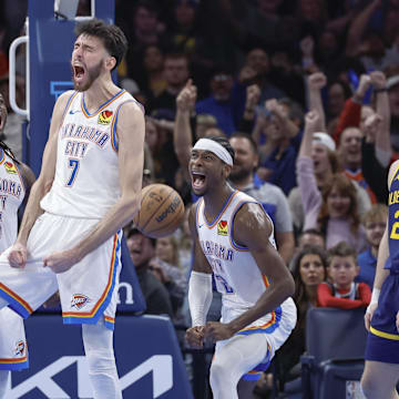 Dec 8, 2023; Oklahoma City, Oklahoma, USA; Oklahoma City Thunder forward Chet Holmgren (7), guard Luguentz Dort (5) and guard Shai Gilgeous-Alexander (2) celebrate after Chet Holmgren scores a basket against the Golden State Warriors during the second half at Paycom Center. Mandatory Credit: Alonzo Adams-Imagn Images