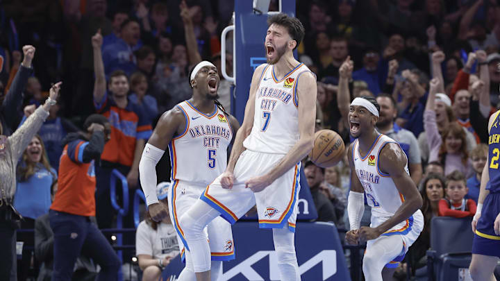 Dec 8, 2023; Oklahoma City, Oklahoma, USA; Oklahoma City Thunder forward Chet Holmgren (7), guard Luguentz Dort (5) and guard Shai Gilgeous-Alexander (2) celebrate after Chet Holmgren scores a basket against the Golden State Warriors during the second half at Paycom Center. Mandatory Credit: Alonzo Adams-Imagn Images