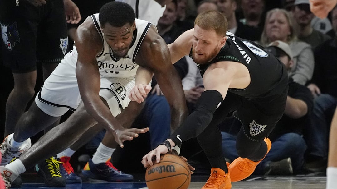 Dec 27, 2025; Minneapolis, Minnesota, USA; Brooklyn Nets center Day'Ron Sharpe (20) competes for the ball with Minnesota Timberwolves guard Donte DiVincenzo (0) in the second quarter at Target Center.