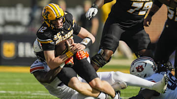 Oct 19, 2024; Columbia, Missouri, USA; Missouri Tigers quarterback Brady Cook (12) is tackled by Auburn Tigers nose tackle Jalen McLeod (35) during the first half at Faurot Field at Memorial Stadium. Mandatory Credit: Jay Biggerstaff-Imagn Images