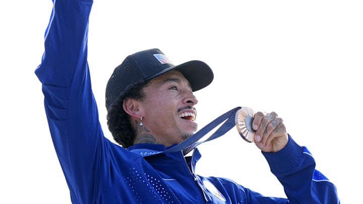 Nyjah Huston of the United States holds up his bronze medal in the menís street finals during the Paris 2024 Olympic Summer Games at La Concorde 3.