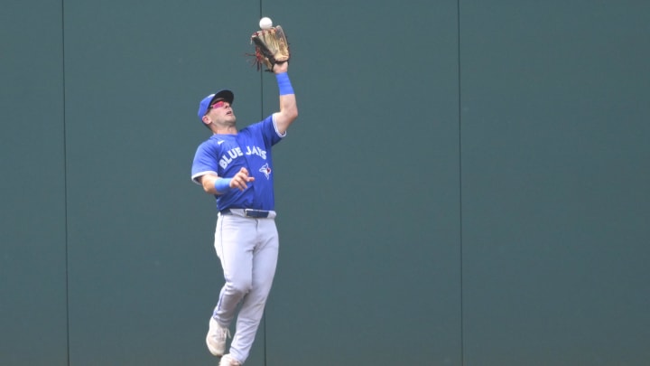 Jun 22, 2024; Cleveland, Ohio, USA; Toronto Blue Jays left fielder Daulton Varsho (25) makes a catch on the warning track in the second inning against the Cleveland Guardians at Progressive Field. Mandatory Credit: David Richard-USA TODAY Sports