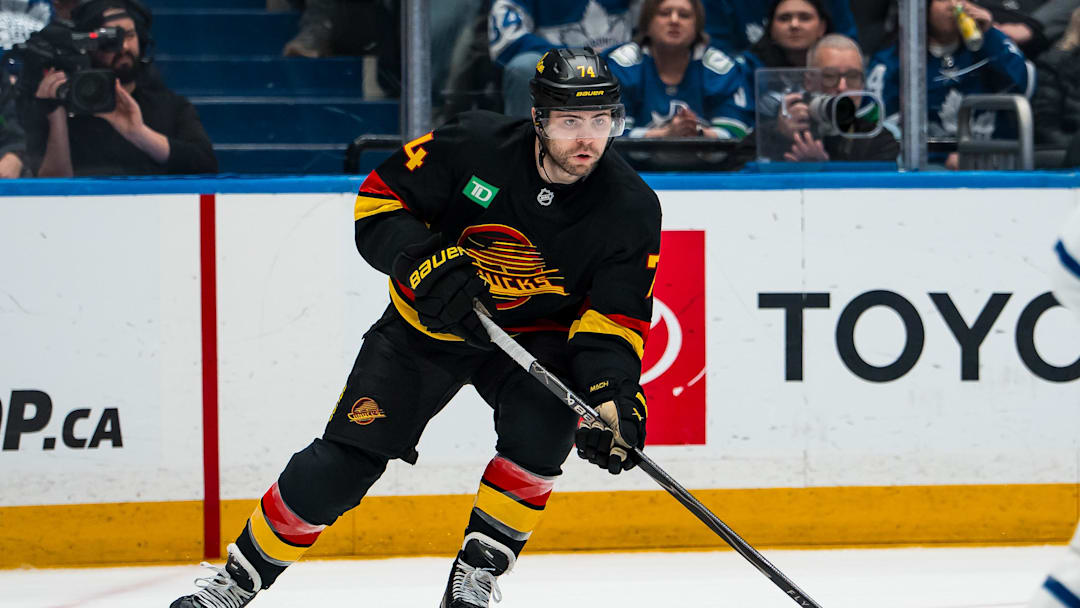Jan 31, 2026; Vancouver, British Columbia, CAN; Vancouver Canucks forward Jake DeBrusk (74) handles the puck against the Toronto Maple Leafs in the second period at Rogers Arena. Mandatory Credit: Bob Frid-Imagn Images