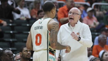 Feb 10, 2024; Coral Gables, Florida, USA; Miami Hurricanes head coach Jim Larranaga talks to guard Matthew Cleveland (0) against the North Carolina Tar Heels during the first half at Watsco Center. Mandatory Credit: Sam Navarro-USA TODAY Sports