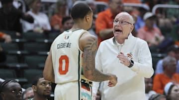 Feb 10, 2024; Coral Gables, Florida, USA; Miami Hurricanes head coach Jim Larranaga talks to guard Matthew Cleveland (0) against the North Carolina Tar Heels during the first half at Watsco Center. Mandatory Credit: Sam Navarro-Imagn Images