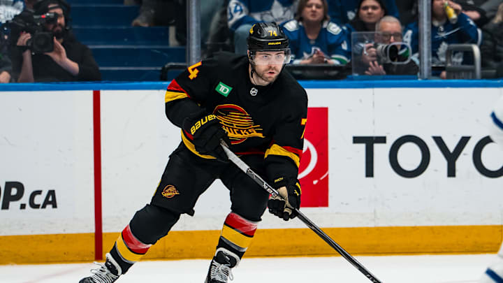 Jan 31, 2026; Vancouver, British Columbia, CAN; Vancouver Canucks forward Jake DeBrusk (74) handles the puck against the Toronto Maple Leafs in the second period at Rogers Arena. Mandatory Credit: Bob Frid-Imagn Images