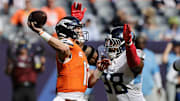 Sep 7, 2025; Denver, Colorado, USA; Tennessee Titans defensive tackle Jeffery Simmons (98) pressures Denver Broncos quarterback Bo Nix (10) in the second half at Empower Field at Mile High. 