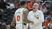 Feb 10, 2024; Coral Gables, Florida, USA; Miami Hurricanes head coach Jim Larranaga talks to guard Matthew Cleveland (0) against the North Carolina Tar Heels during the first half at Watsco Center. Mandatory Credit: Sam Navarro-Imagn Images