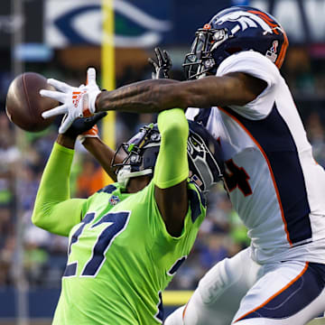 Sep 12, 2022; Seattle, Washington, USA; Denver Broncos cornerback Riq Woolen (27) breaks up a pass intended for Denver Broncos wide receiver Courtland Sutton (14) during the third quarter at Lumen Field. Images