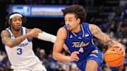 Feb 5, 2025; Memphis, Tennessee, USA; Tulsa Golden Hurricane guard Braeden Carrington (4) drives to the basket against Memphis Tigers guard Colby Rogers (3) during the second half at FedExForum. Mandatory Credit: Wesley Hale-Imagn Images