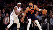 Mar 17, 2025; New York, New York, USA; New York Knicks center Karl-Anthony Towns (32) controls the ball against Miami Heat center Bam Adebayo (13) during the fourth quarter at Madison Square Garden. Mandatory Credit: Brad Penner-Imagn Images