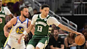 Oct 30, 2025; Milwaukee, Wisconsin, USA; Milwaukee Bucks guard Ryan Rollins (13) reaches for the ball against Golden State Warriors guard Stephen Curry (30) in the first quarter at Fiserv Forum. Mandatory Credit: Benny Sieu-Imagn Images