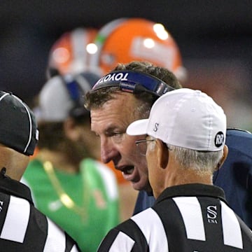 Sep 7, 2024; Champaign, Illinois, USA; Illinois Fighting Illini head coach Bret Bielema talks with officials during the second half against the Kansas Jayhawks at Memorial Stadium. Mandatory Credit: Ron Johnson-Imagn Images