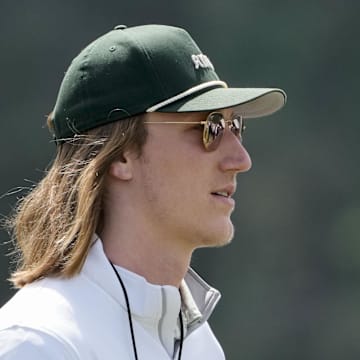 Apr 12, 2025; Augusta, Georgia, USA; Jacksonville Jaguars quarterback Trevor Lawrence walks past no. 10 during the third round of the Masters Tournament at Augusta National Golf Club. Mandatory Credit: Kyle Terada-Imagn Images
