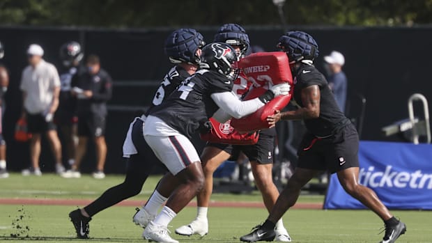 Jul 24, 2025; Houston, TX, USA; Houston Texans tight end Dalton Schultz (86) and tackle Cam Robinson (74) and tight end Brevi